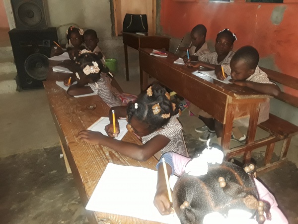 Group of school children writing
