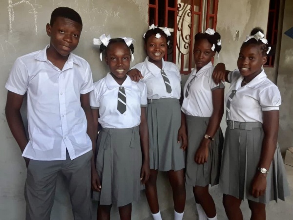 Five school kids in uniforms