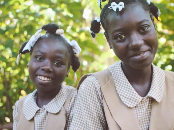 Two smiling school girls in uniform
